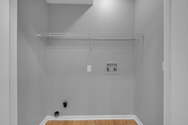 clothes washing area featuring hookup for a washing machine, hardwood / wood-style floors, and electric dryer hookup