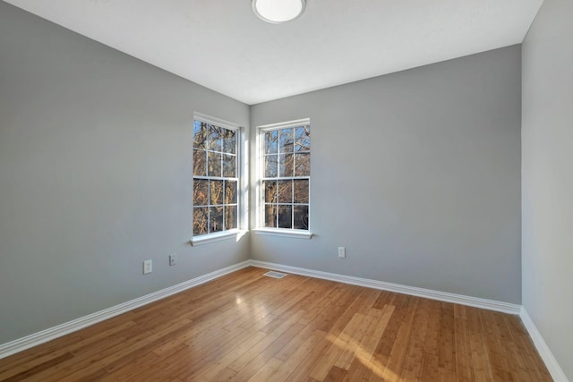 spare room with hardwood / wood-style flooring