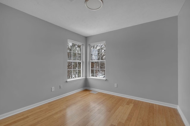 spare room with light hardwood / wood-style flooring