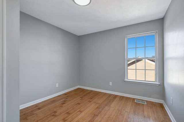 spare room featuring light wood-type flooring