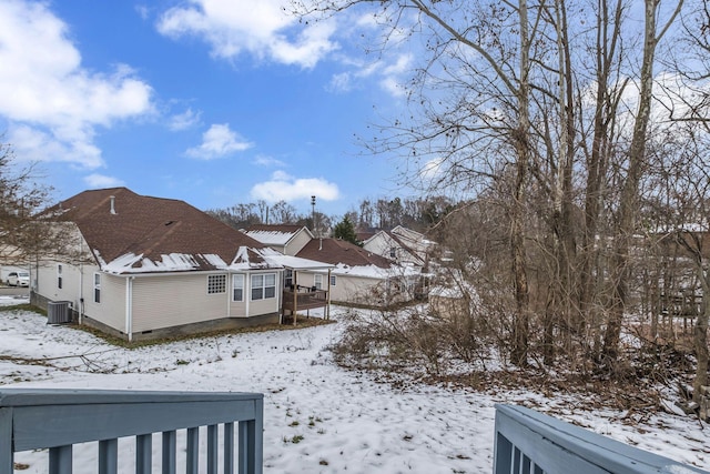 yard layered in snow with central AC