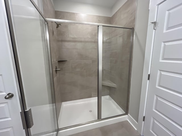 bathroom with a shower with door