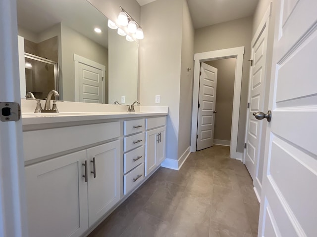 bathroom featuring vanity and a shower with door