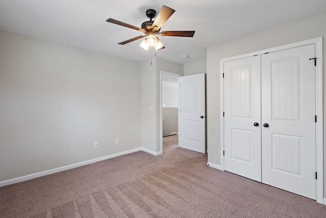 unfurnished bedroom featuring a closet, ceiling fan, and light carpet