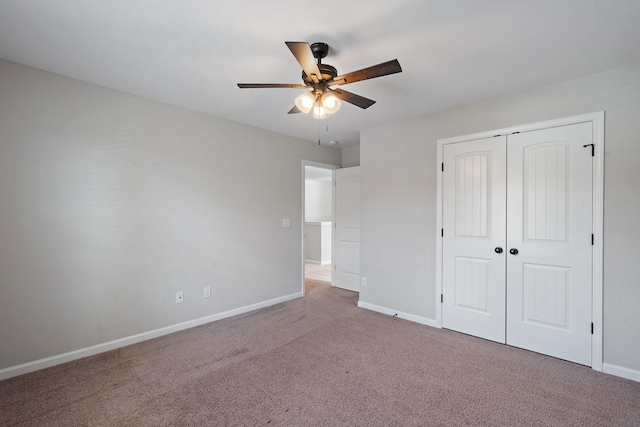 unfurnished bedroom featuring carpet floors, a closet, and ceiling fan