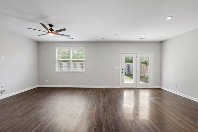 unfurnished room with dark wood-type flooring and ceiling fan