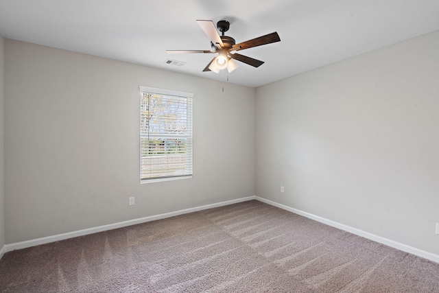 empty room featuring ceiling fan and carpet flooring