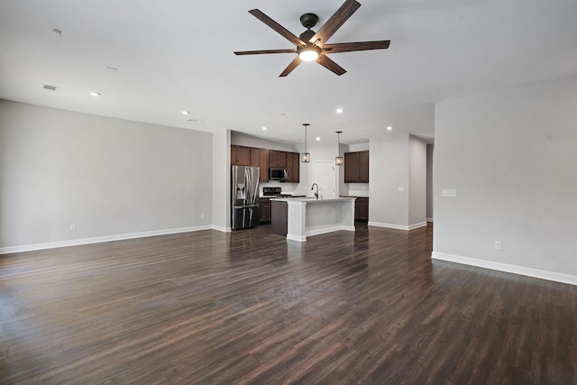 unfurnished living room with sink, dark hardwood / wood-style floors, and ceiling fan