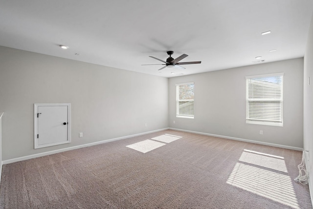 unfurnished room with ceiling fan and light carpet