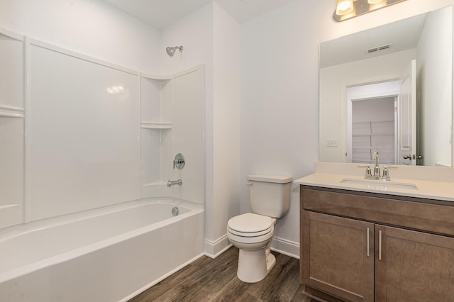 full bathroom with shower / washtub combination, wood-type flooring, toilet, and vanity