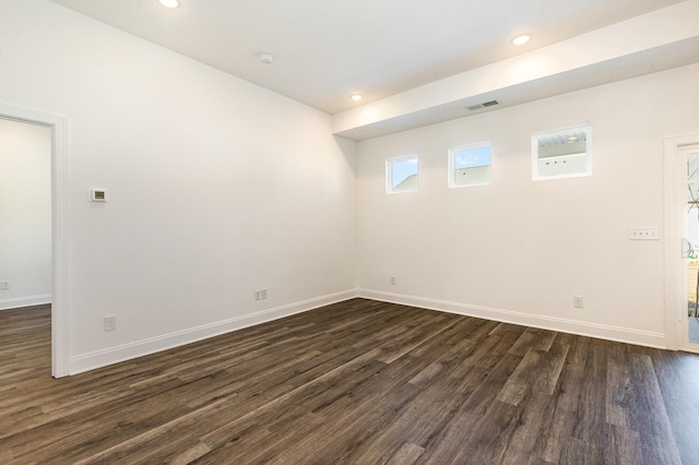 empty room featuring dark hardwood / wood-style flooring