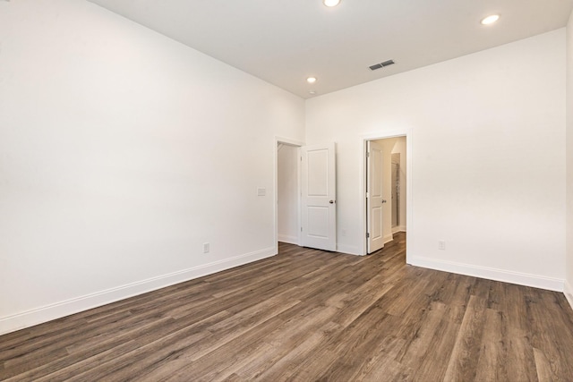 empty room with dark wood-type flooring