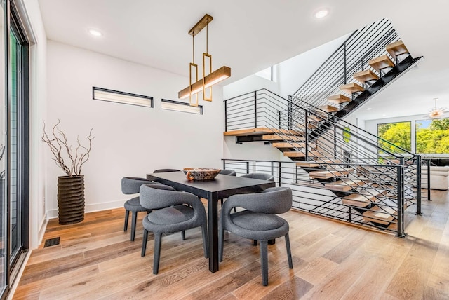 dining room featuring stairs, light wood-type flooring, visible vents, and recessed lighting