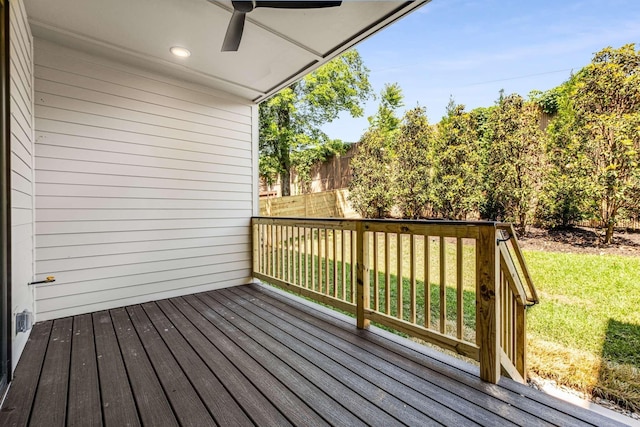 wooden deck featuring fence, a ceiling fan, and a lawn