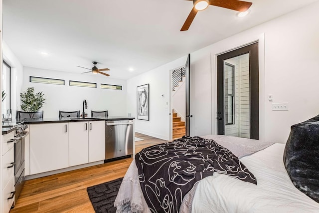 bedroom featuring light wood-type flooring, a sink, and recessed lighting