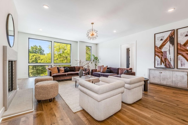 living area featuring light wood-style flooring and recessed lighting