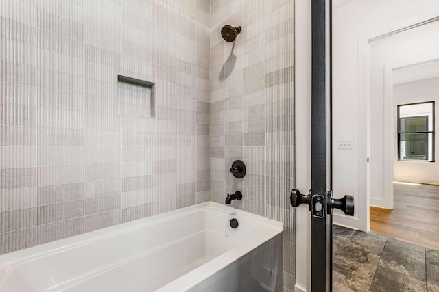 full bath featuring baseboards and shower / bathtub combination