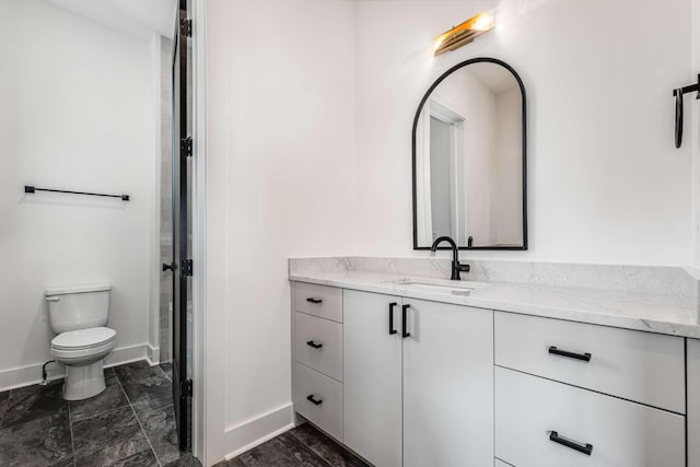 full bath with toilet, baseboards, and vanity