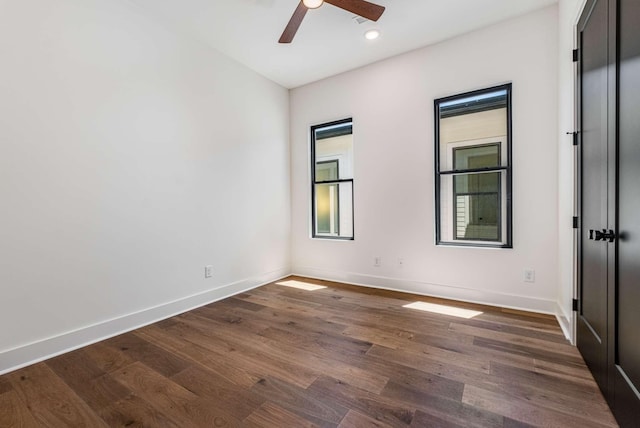 empty room featuring a ceiling fan, recessed lighting, dark wood-style flooring, and baseboards