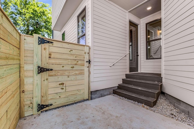 entrance to property featuring a gate and fence