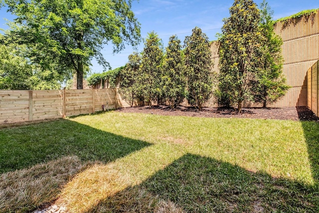 view of yard with a fenced backyard