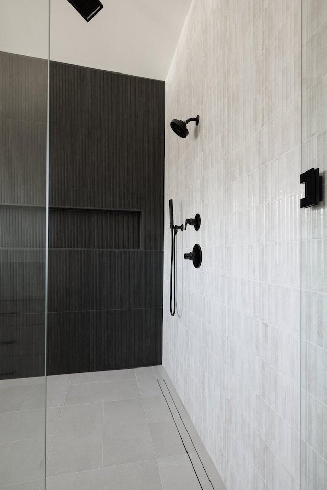 full bath featuring a tile shower and tile patterned floors