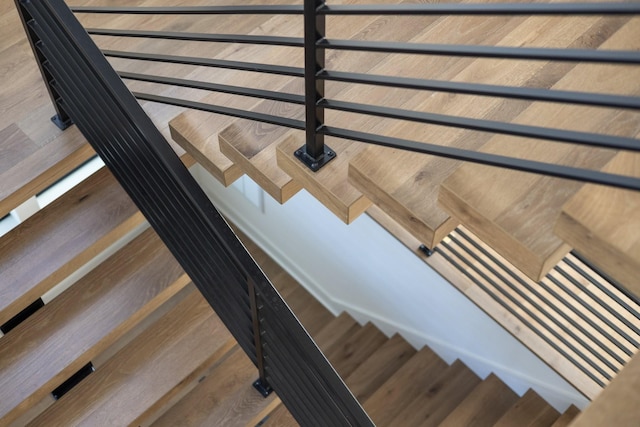 staircase with wood finished floors