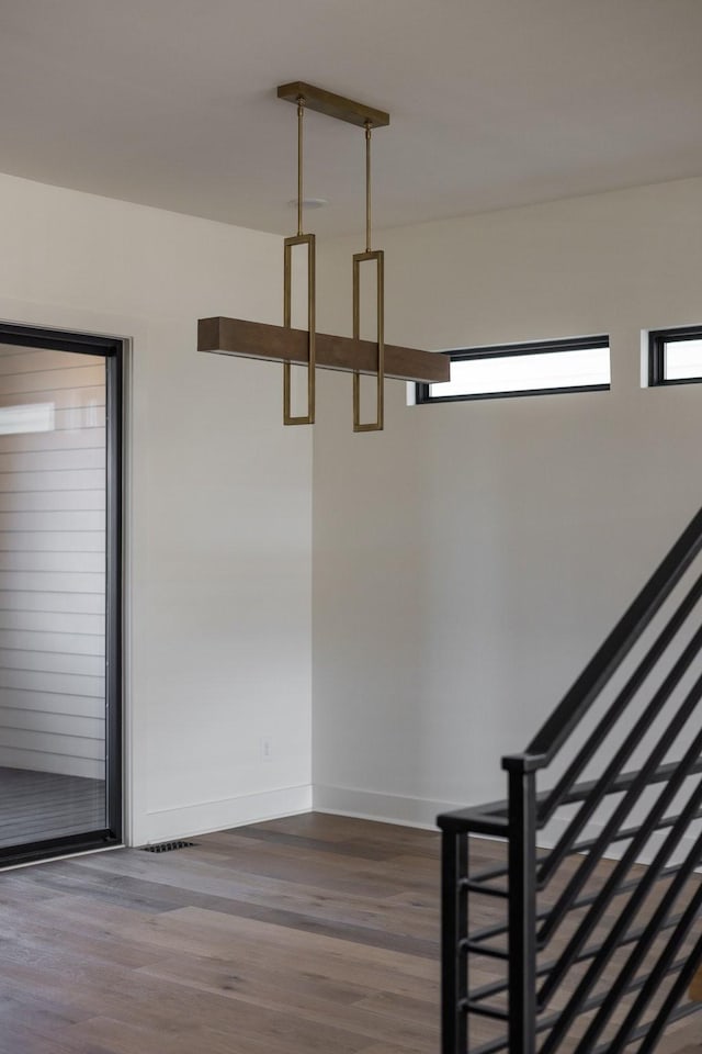 interior space featuring baseboards and wood finished floors