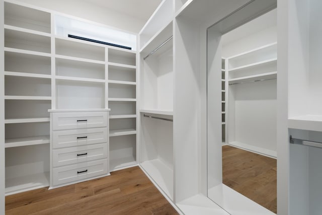 walk in closet featuring wood finished floors