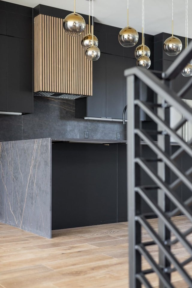 interior details featuring tasteful backsplash and wood finished floors