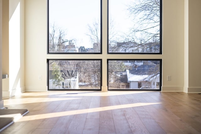 interior space with wood finished floors and baseboards