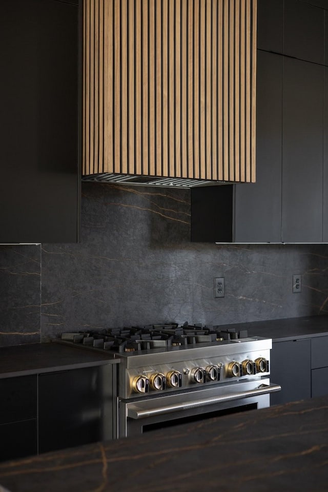 kitchen with gas stove, decorative backsplash, and extractor fan