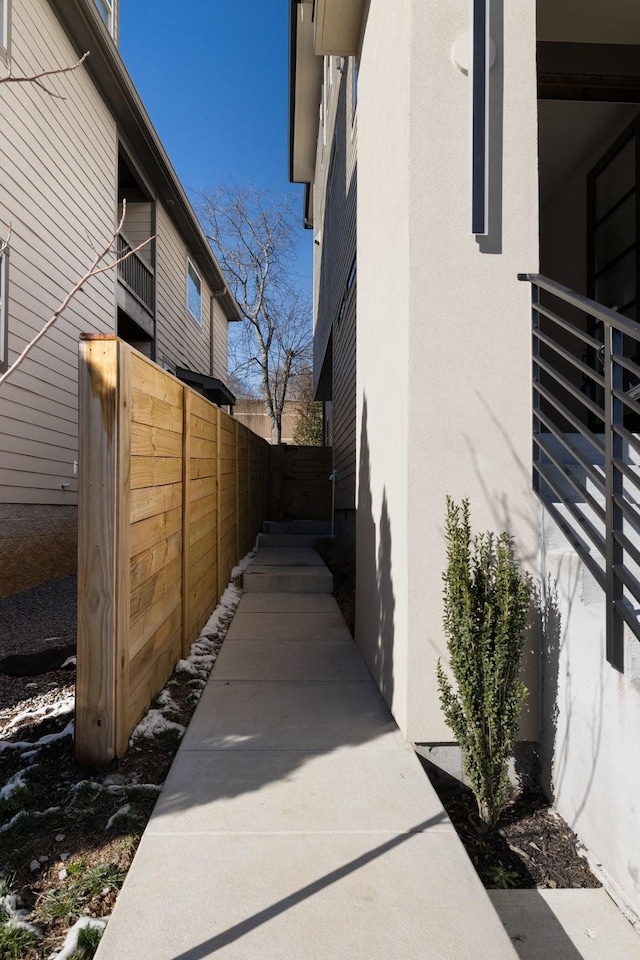 view of home's exterior featuring fence and stucco siding