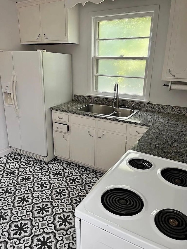 kitchen with white cabinetry, sink, and white appliances