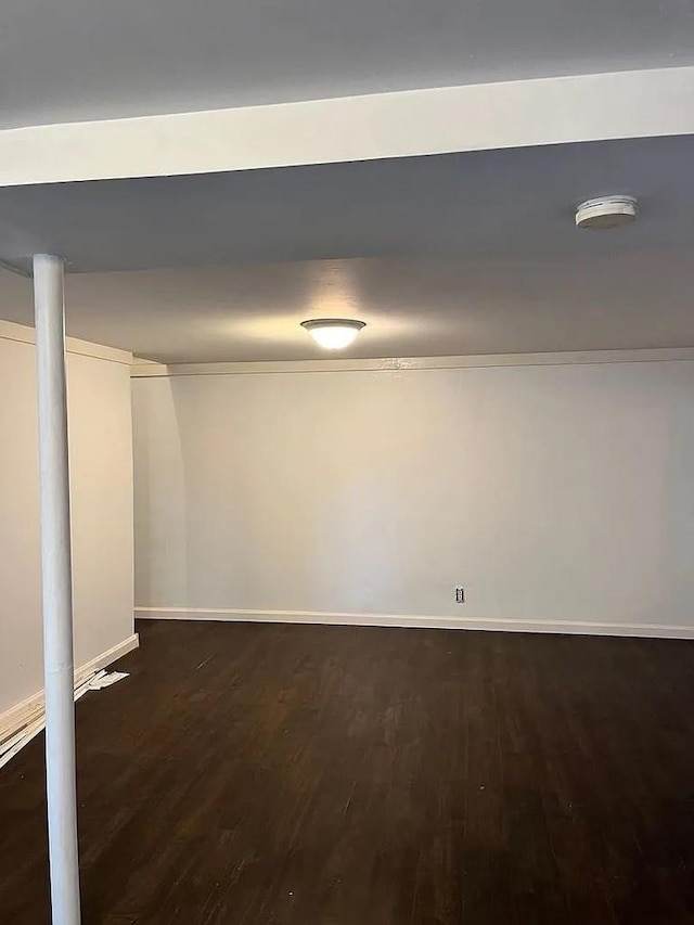 basement featuring dark hardwood / wood-style flooring