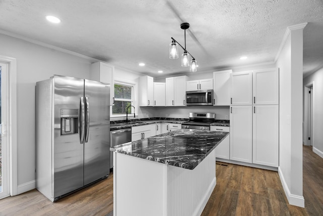 985 Watauga Dr, Cookeville, TN 38501 - kitchen featuring white cabinets, a center island, appliances with stainless steel finishes, and a textured ceiling