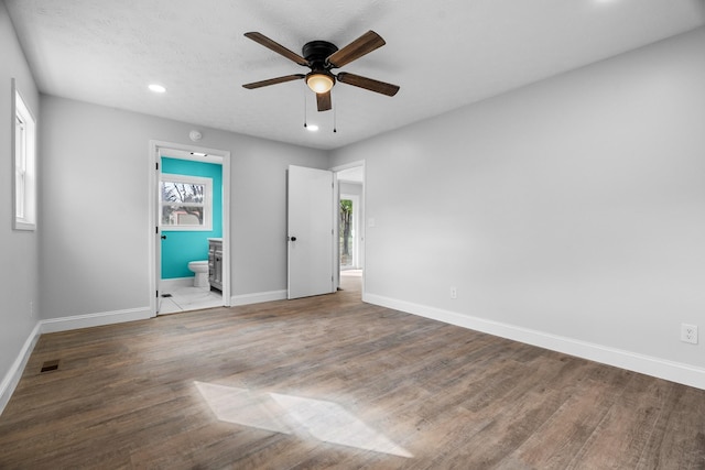 985 Watauga Dr, Cookeville, TN 38501 - unfurnished bedroom with ceiling fan, connected bathroom, multiple windows, and wood-type flooring