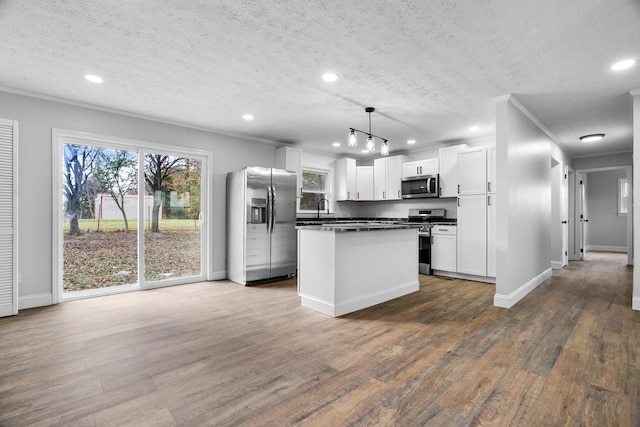985 Watauga Dr, Cookeville, TN 38501 - kitchen with pendant lighting, appliances with stainless steel finishes, a textured ceiling, white cabinetry, and dark hardwood / wood-style floors