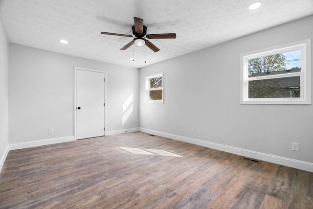 985 Watauga Dr, Cookeville, TN 38501 - unfurnished room with ceiling fan, a textured ceiling, a wealth of natural light, and dark hardwood / wood-style flooring