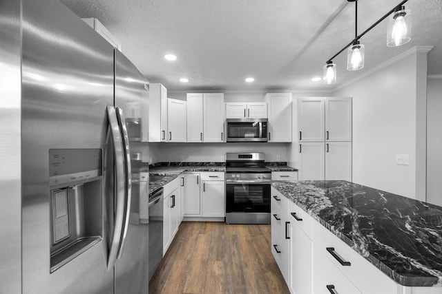 985 Watauga Dr, Cookeville, TN 38501 - kitchen featuring decorative light fixtures, white cabinetry, stainless steel appliances, and dark stone counters