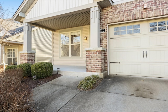 entrance to property featuring covered porch and a garage