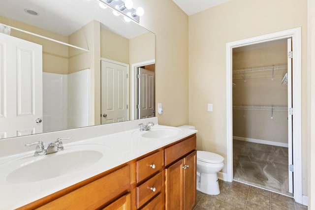 bathroom featuring toilet and vanity