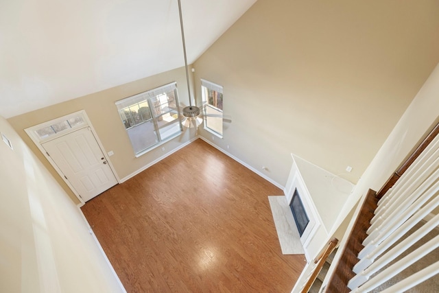 foyer featuring hardwood / wood-style flooring and high vaulted ceiling