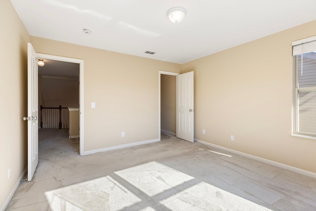 unfurnished bedroom with light colored carpet