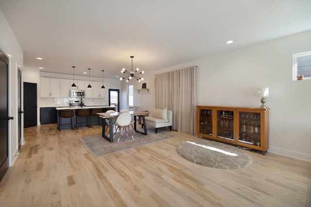 dining space featuring a chandelier and light hardwood / wood-style floors