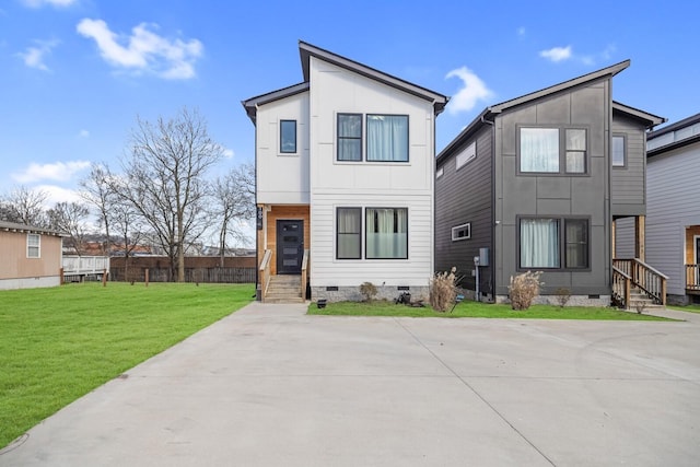 modern home featuring a front lawn