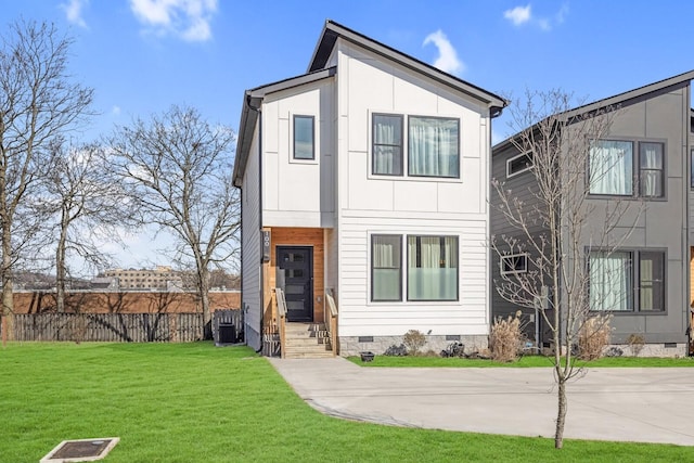 view of front of property with a front yard and central AC unit