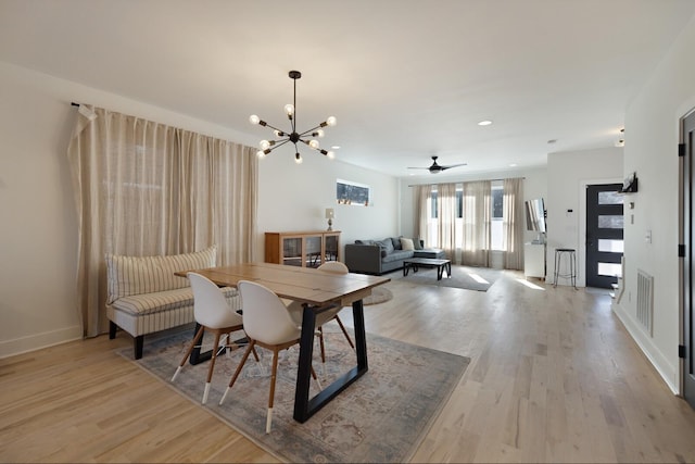 dining room featuring light hardwood / wood-style flooring and an inviting chandelier