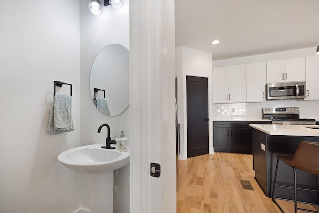 interior space with hardwood / wood-style flooring and decorative backsplash