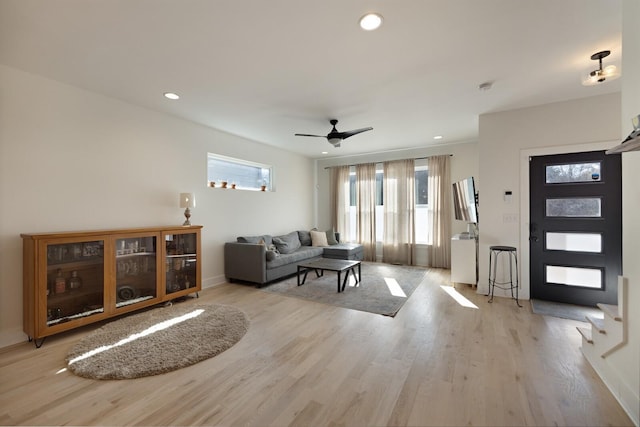 living room featuring ceiling fan and light wood-type flooring